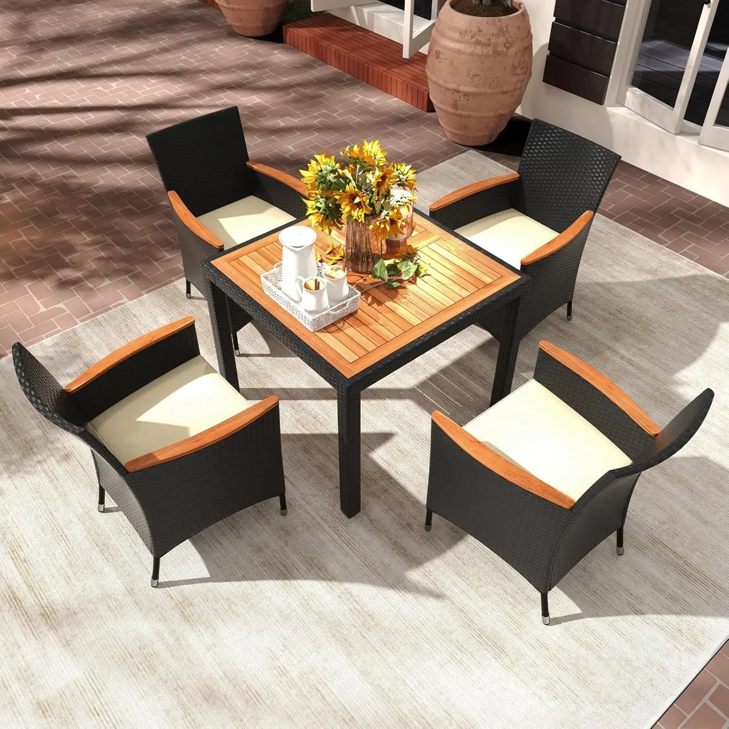 Stylish rattan garden furniture full set sofa set on a sunny balcony with decorative plants.