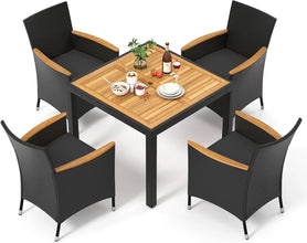 Modern rattan garden furniture set placed in a lush green backyard with soft lighting.