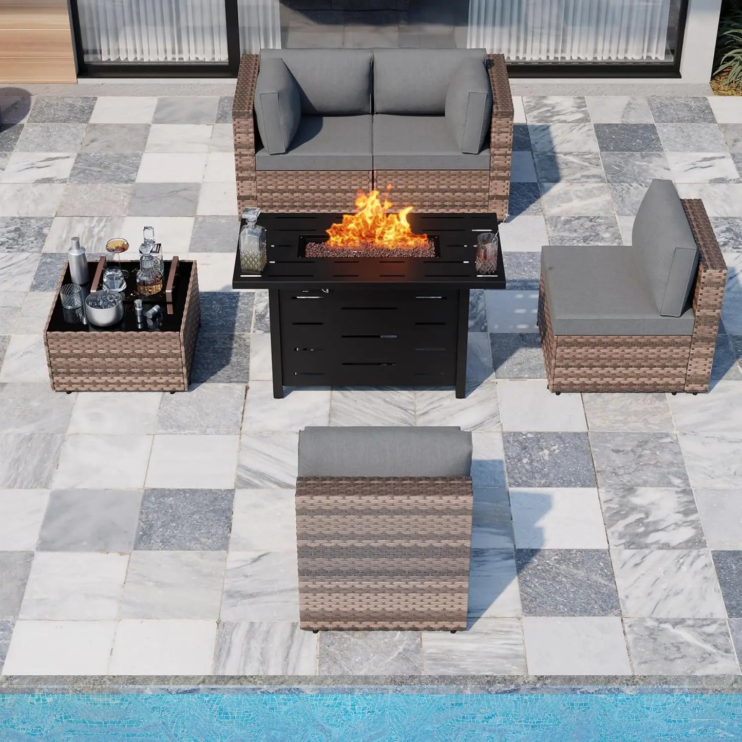 Outdoor garden patio furniture arranged beside a swimming pool in a modern garden.