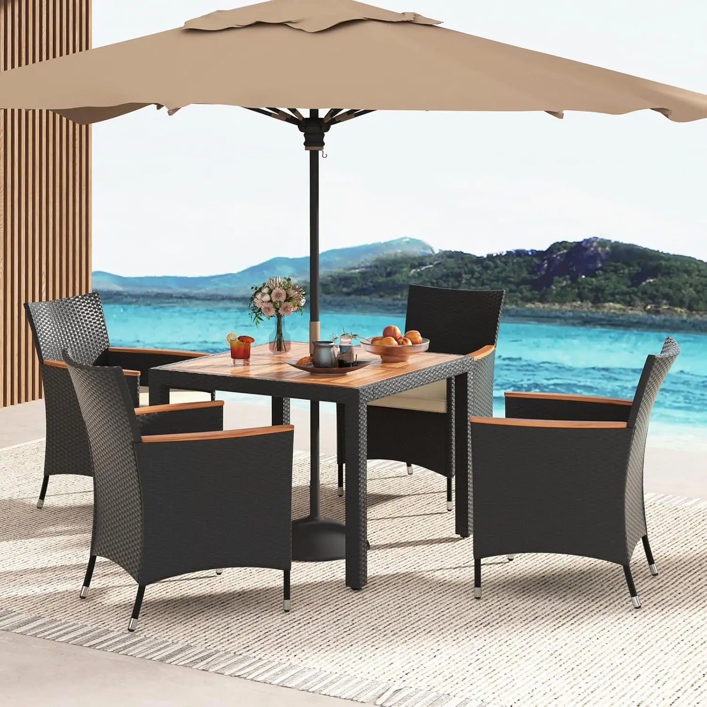 Stylish rattan garden furniture sofa set on a sunny balcony with decorative plants.