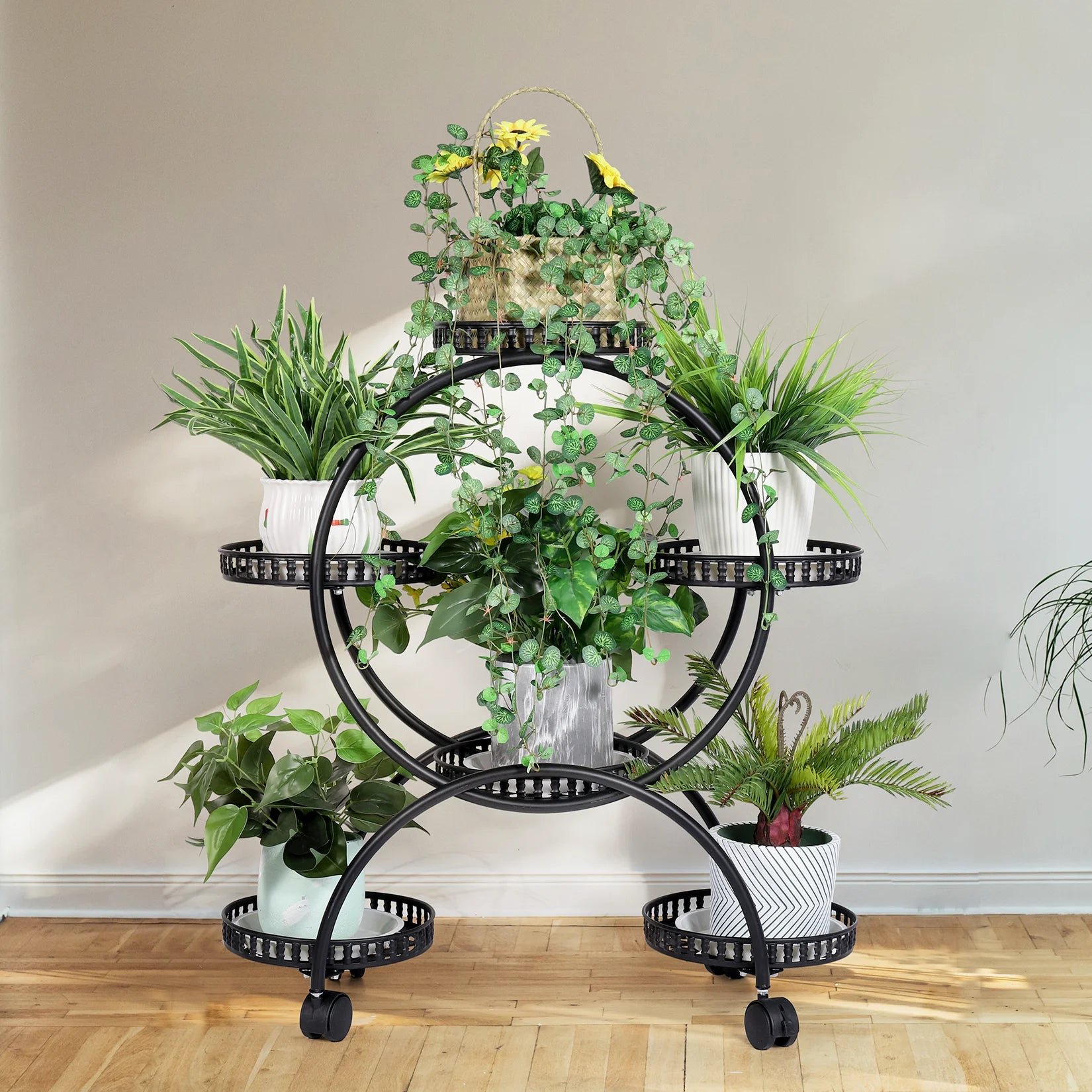 Modern metal plant stand with potted flowers on balcony