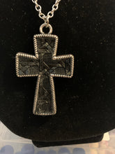 Mens silver cross with black embossed leather center necklace.
