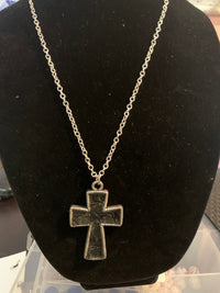 Mens silver cross with black embossed leather center necklace.