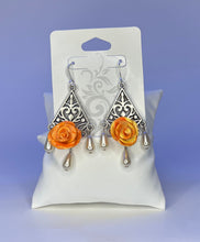 Handmade orange and yellow mixed clay rose earrings on silver chandelier base
