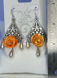 Handmade orange and yellow mixed clay rose earrings on silver chandelier base