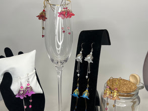 Hand painted lucite flower earring sets in varied colors