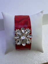 Embossed leather bracelets with clear rhinestone jewel in a floral pattern