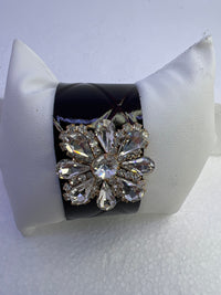 Embossed leather bracelets with clear rhinestone jewel in a floral pattern