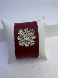Embossed leather bracelets with clear rhinestone jewel in a floral pattern
