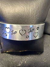 Silver plated metal stamped bracelet with hearts and love