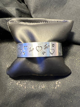 Silver plated metal stamped bracelet with hearts and love