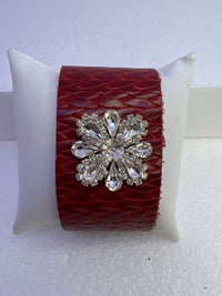 Embossed leather bracelets with clear rhinestone jewel in a floral pattern