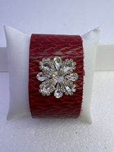 Embossed leather bracelets with clear rhinestone jewel in a floral pattern