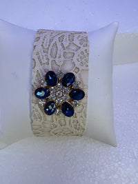 Leather bracelets in blue or cream color with blue and clear floral rhinestone embellishment