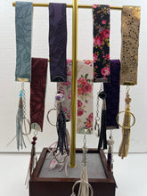 Embossed and patterned leather wrist holder key chains