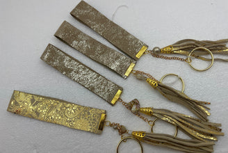 Embossed and patterned leather wrist holder key chains