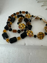 Set of 3 beaded bracelets in black and shades of gold