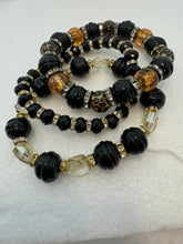 Set of 3 beaded bracelets in black and shades of gold plus leopard patterns