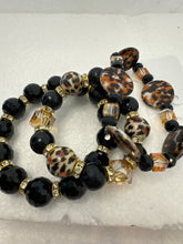 Set of 3 beaded bracelets in black and shades of gold plus leopard patterns