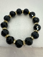 Set of 3 beaded bracelets in black and shades of gold plus leopard patterns