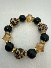 Set of 3 beaded bracelets in black and shades of gold plus leopard patterns