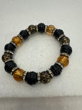 Set of 3 beaded bracelets in black and shades of gold plus leopard patterns