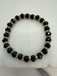 Set of 3 beaded bracelets in black and shades of gold plus leopard patterns