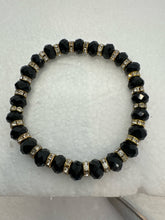 Set of 3 beaded bracelets in black and shades of gold plus leopard patterns