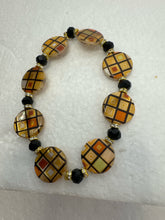 Set of 3 beaded bracelets in black and shades of gold