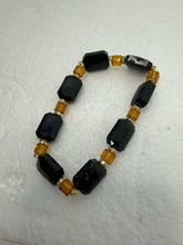 Set of 3 beaded bracelets in black and shades of gold
