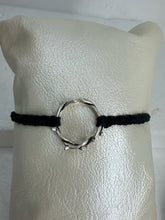These silver crown of thorns bracelets are banded with black or red  macrome knots