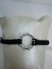 These silver crown of thorns bracelets are banded with black or red  macrome knots