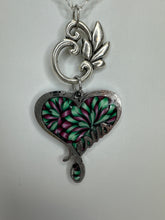 Silver plated  clay filled heart bearing the name of Jesus and adorned with green beads