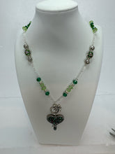 Silver plated  clay filled heart bearing the name of Jesus and adorned with green beads