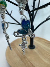 Crosses that say faith and have a butterfly on them adorned with blue cloisonné beads