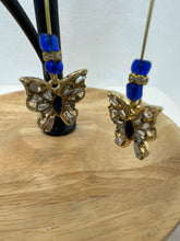Gold 1 3/4 inch hoops with flower adornment and dangling butterfy