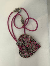 Silver filigree heart clay filled with patterned clay and on a leather braided cording necklace