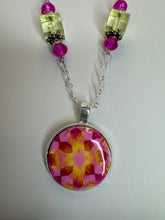 Round pendants filled with patterned polymer clay in various colors on dainty coordinated chains