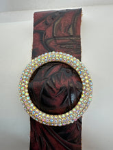 Rhinestone encrusted circle on embossed leather of different shades