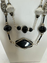Black wire wrapped stone in a double strand necklace with silver and black beads