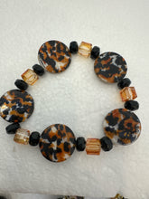 Set of 3 beaded bracelets in black and shades of gold plus leopard patterns