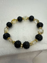 Set of 3 beaded bracelets in black and shades of gold plus leopard patterns