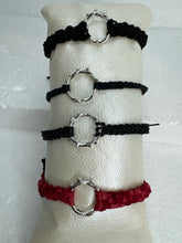 These silver crown of thorns bracelets are banded with black or red  macrome knots