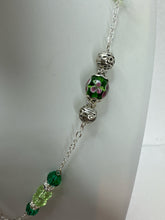 Silver plated  clay filled heart bearing the name of Jesus and adorned with green beads