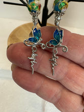 Crosses that say faith and have a butterfly on them adorned with blue cloisonné beads