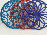 Resin hot pads in floral and swirl patterns