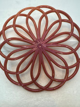 Resin hot pads in floral and swirl patterns
