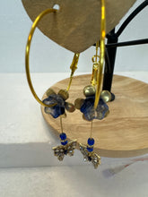 Gold 1 3/4 inch hoops with flower adornment and dangling butterfy