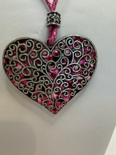 Silver filigree heart clay filled with patterned clay and on a leather braided cording necklace