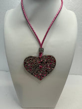 Silver filigree heart clay filled with patterned clay and on a leather braided cording necklace